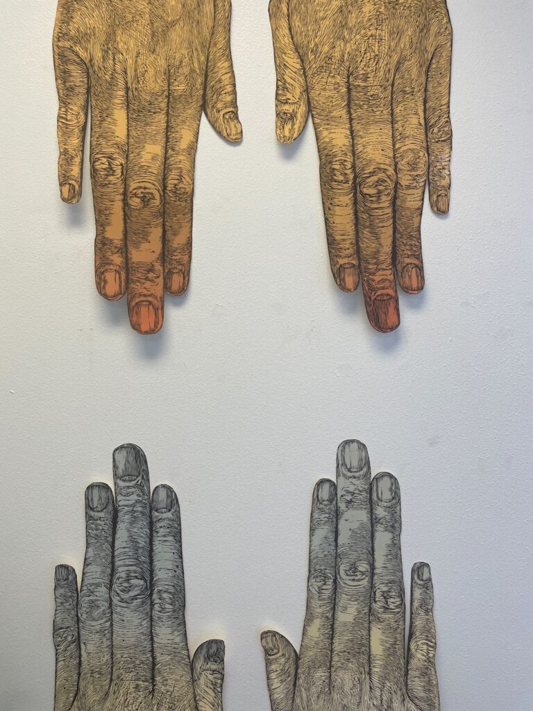 Two sets of hands printed on paper by artist Marne Elmore.